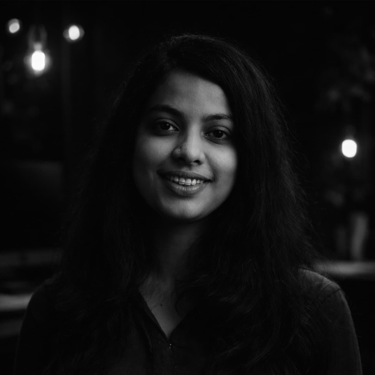 Ancy George focused at a drafting table designing letterforms